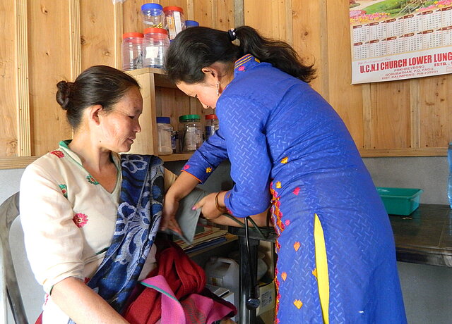 Dorfgesundheitshelferin in Indien Dorfgesundheitshelferin misst den Blutdruck einer Patientin in Indien
